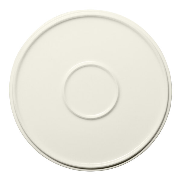 A round cream-colored porcelain plate with a raised rim.
