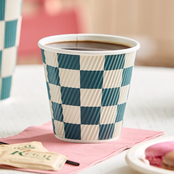 A navy and white checkered paper hot cup filled with coffee.