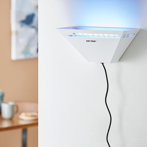 A white metal trapezoidal wall sconce LED insect light trap with a power cord, designed for indoor use.