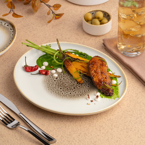 An irregular oval porcelain platter with a brown and cream color and a raised rim.