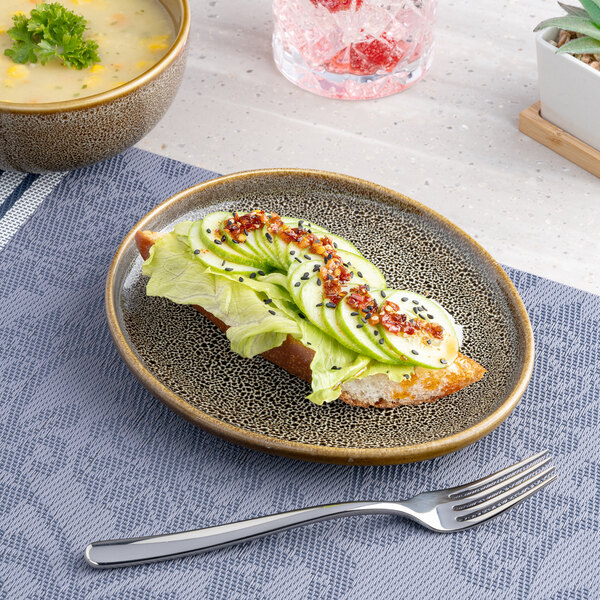 An oval brown porcelain platter with an irregular raised rim, featuring a speckled design.