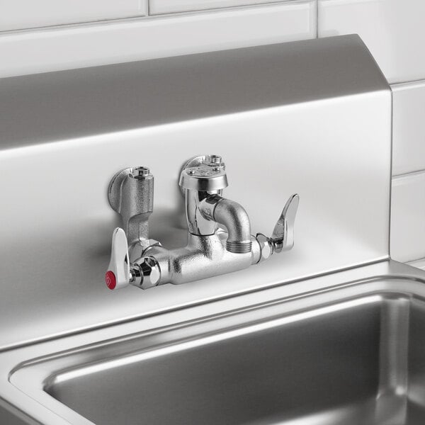 A wall-mounted chrome service sink faucet with two lever handles, a vacuum breaker, and adjustable arm centers.