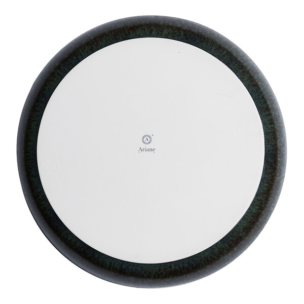 A round porcelain coupe plate with a black rim and white center.