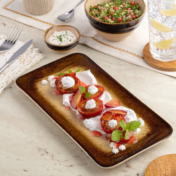 A brown rectangular wide rim porcelain platter with a food presentation.
