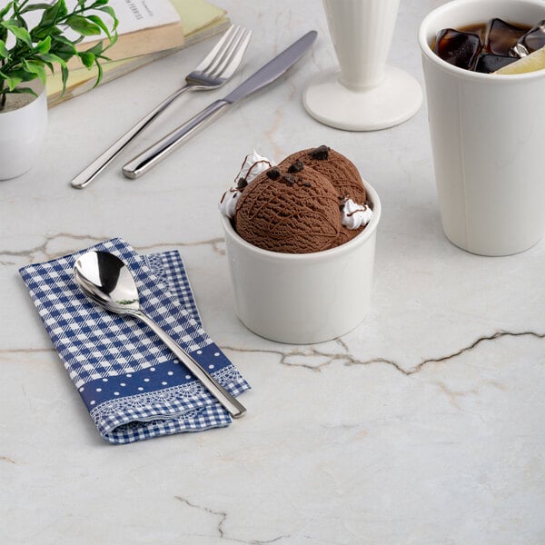 A small ivory round porcelain dessert bowl filled with chocolate ice cream.
