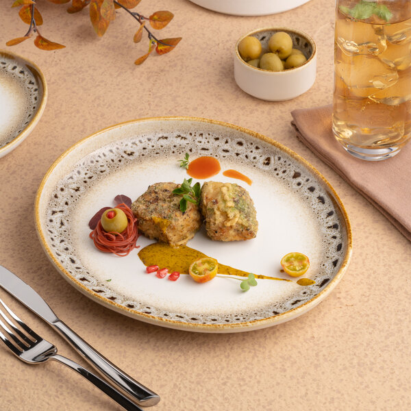 An oval porcelain platter with a brown and cream spotted rim, featuring a raised edge.