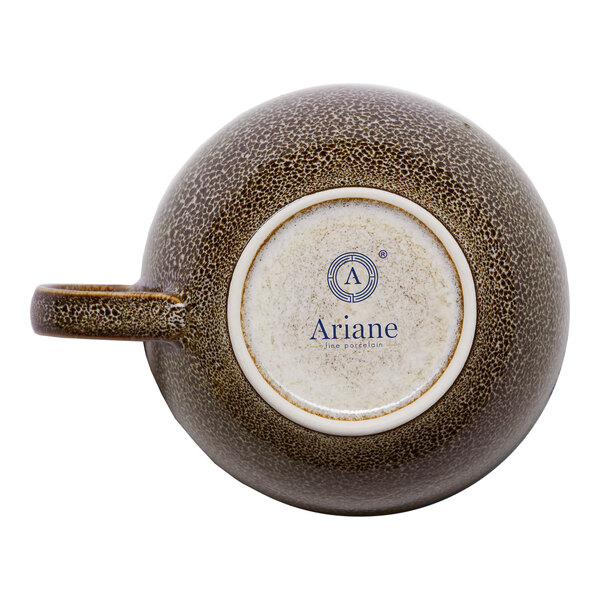A brown porcelain cappuccino cup with a speckled design, shown upside down to display the Ariane brand on the bottom.
