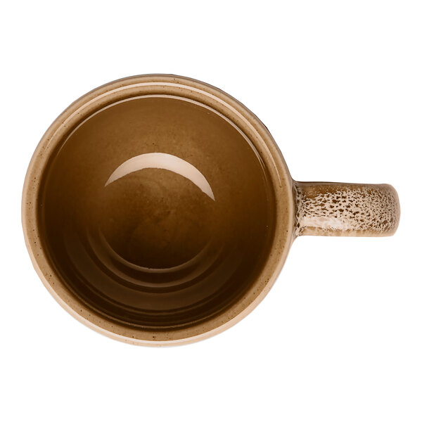 A brown porcelain espresso cup with a handle, viewed from above.