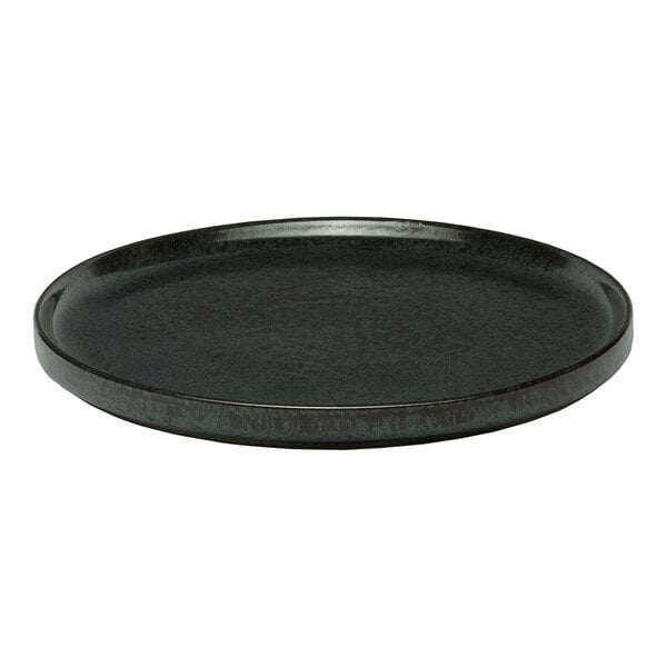 A black round porcelain plate with a raised rim.