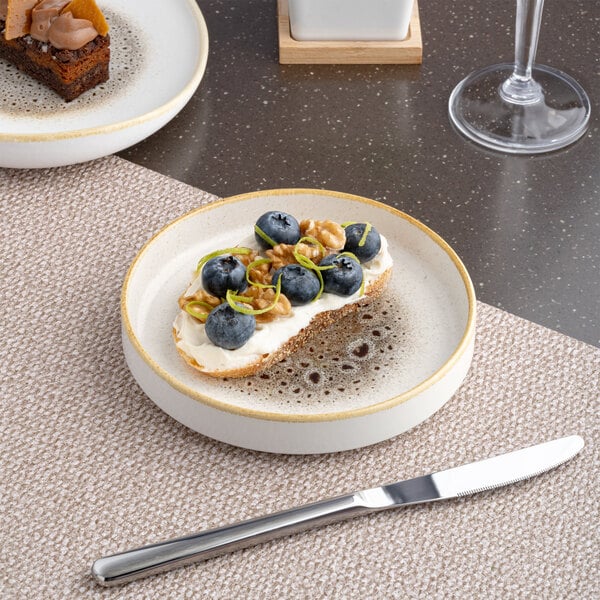 A round brown and cream porcelain plate with a raised rim.