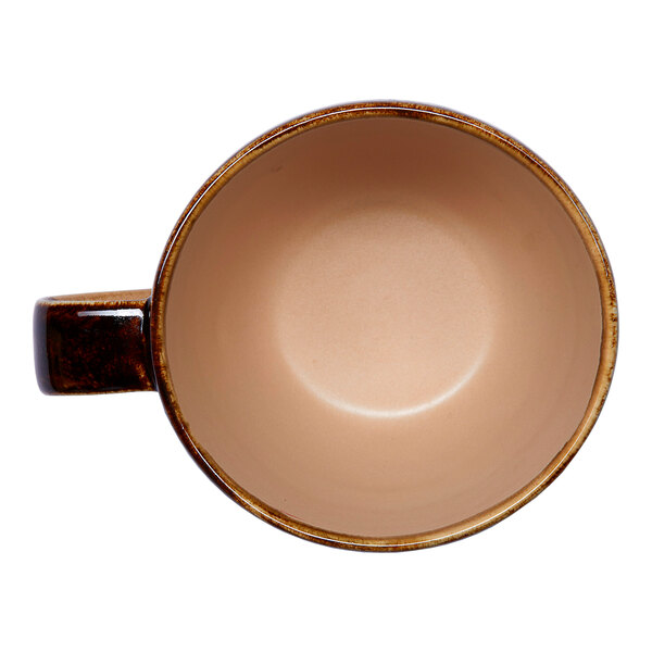 A brown porcelain tea cup with an irregular shape and a handle, viewed from above.