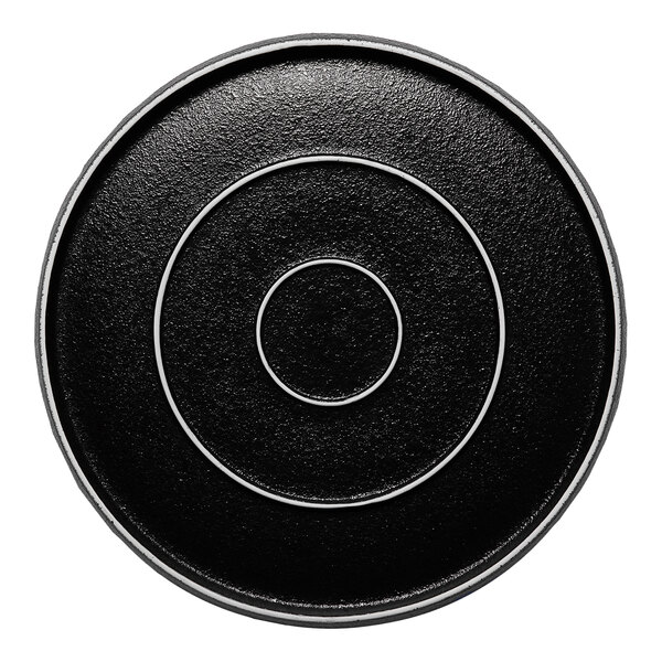 A black round porcelain plate with concentric circle designs.