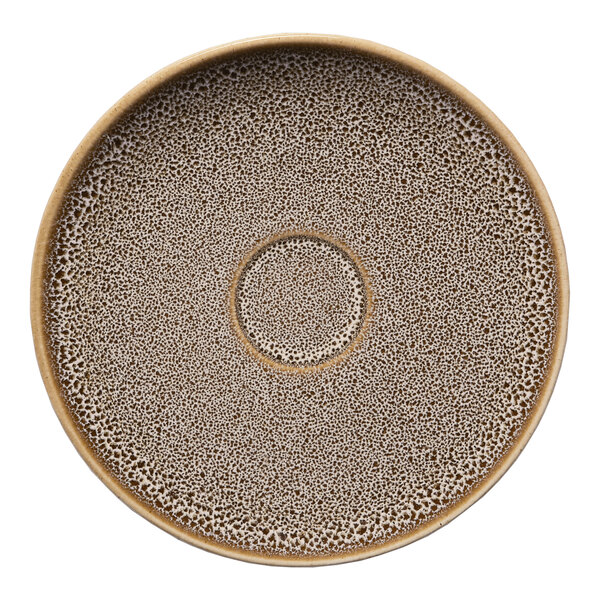 A round brown porcelain espresso cup saucer with a speckled pattern and a central indentation.