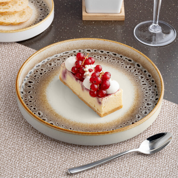 A round porcelain plate with a brown and cream spotted rim and a raised edge.