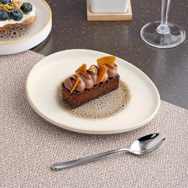 An irregular oval porcelain platter with a brown and cream color scheme and a raised rim.