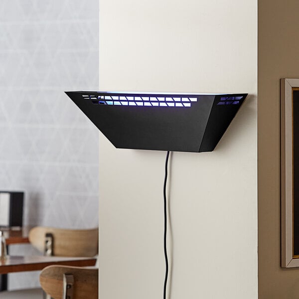 A black metal trapezoidal wall sconce LED insect light trap with a visible power cord, designed for indoor use.