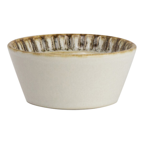 A small round birch-colored porcelain condiment dish with a textured rim.