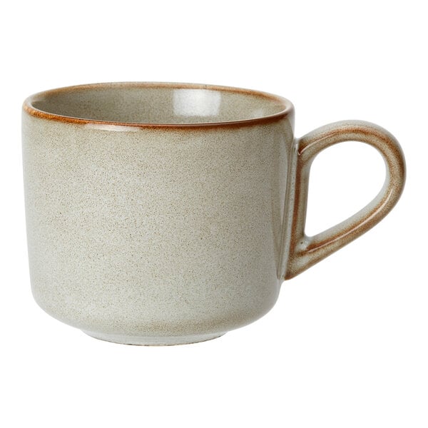 A beige porcelain cappuccino cup with a brown rim and handle.
