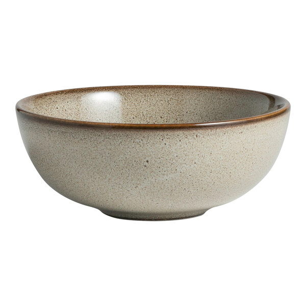 A round, speckled beige porcelain bowl with a slightly darker rim.