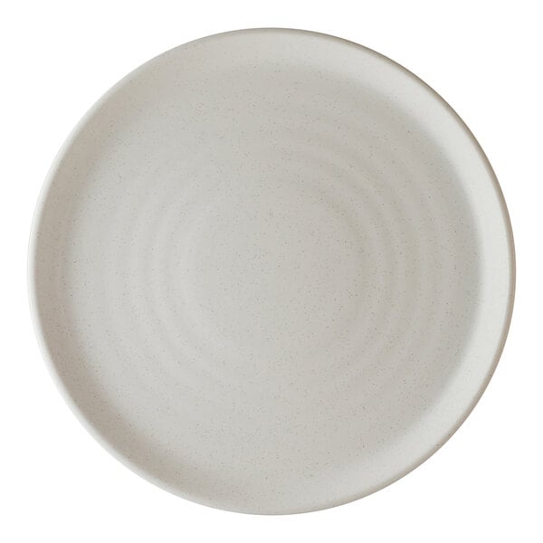 A round, off-white porcelain plate with a subtle textured pattern.