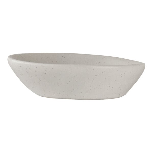 A small, white, speckled porcelain oil dish with a shell-like shape.