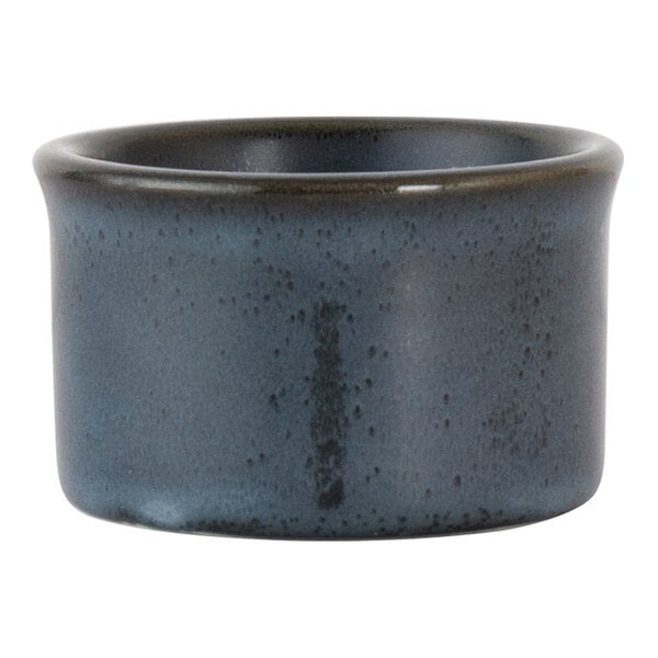 A round, dark blue porcelain ramekin with a speckled finish.