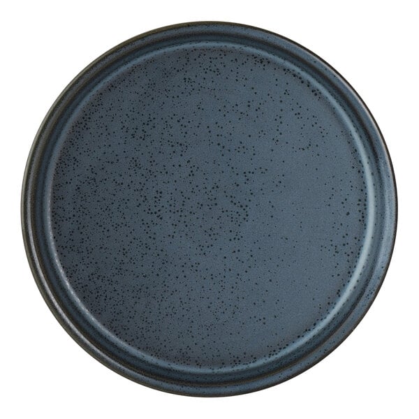 A round, dark blue porcelain serving tray with a speckled pattern.