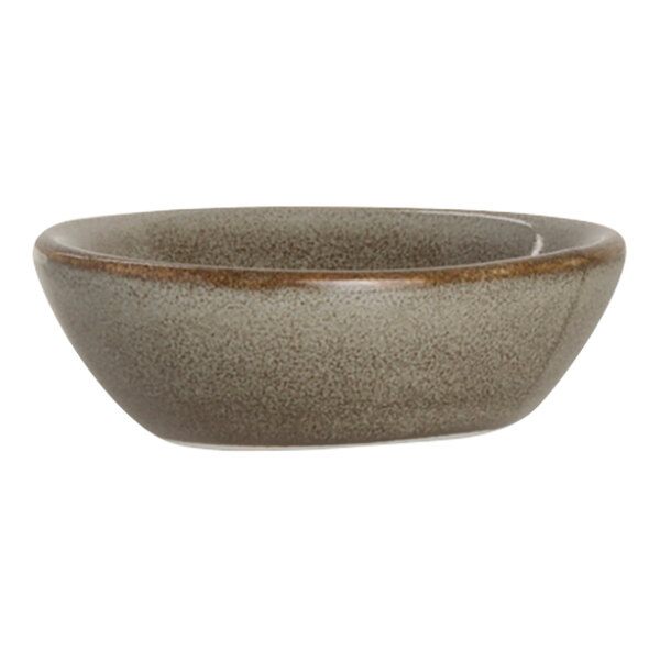 A small, round, brown-speckled porcelain spice dish.