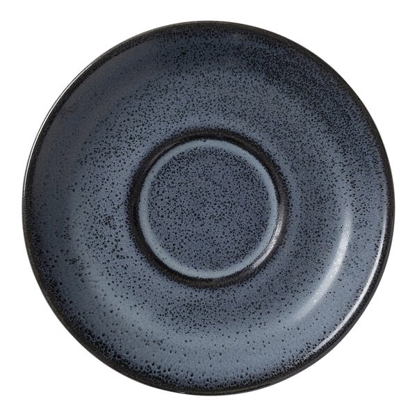 A round, dark blue speckled porcelain saucer with a recessed center.