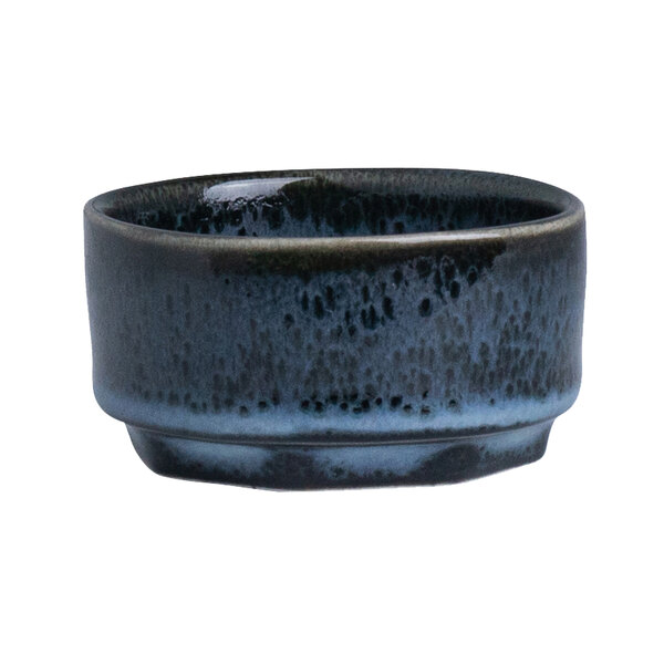 A small round blue and black porcelain ramekin.
