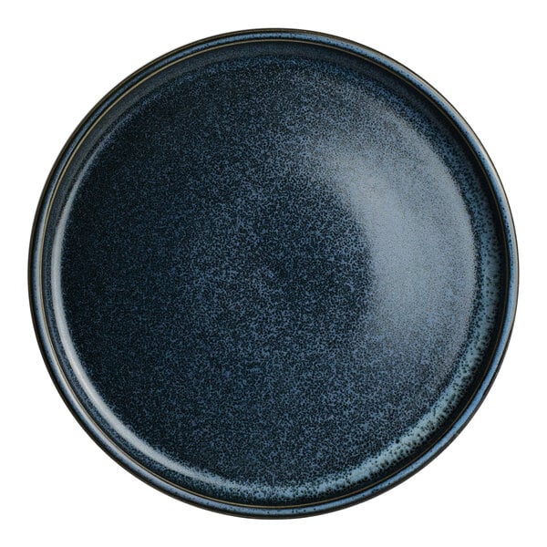 A round, dark blue speckled porcelain plate from The Potter's Collection by Robert Gordon.