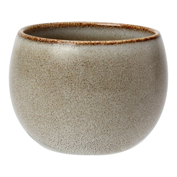 A round, speckled porcelain sugar pot with a slightly flared rim and a neutral-toned finish.