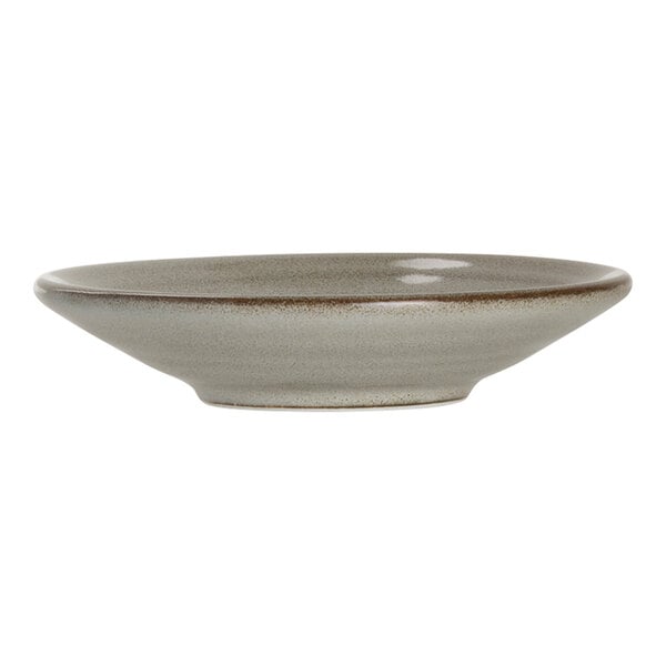 A small round porcelain coupe plate with a subtle earthy glaze.