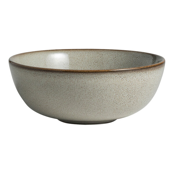 A round, speckled porcelain bowl with a slightly raised rim and a neutral-toned finish.