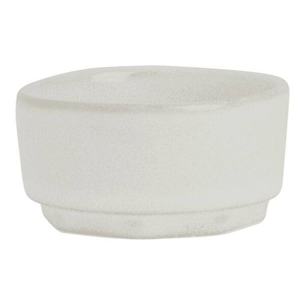 A small, round, white porcelain ramekin.