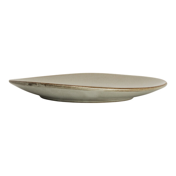 A round, beige porcelain coupe plate with a slightly irregular shape.