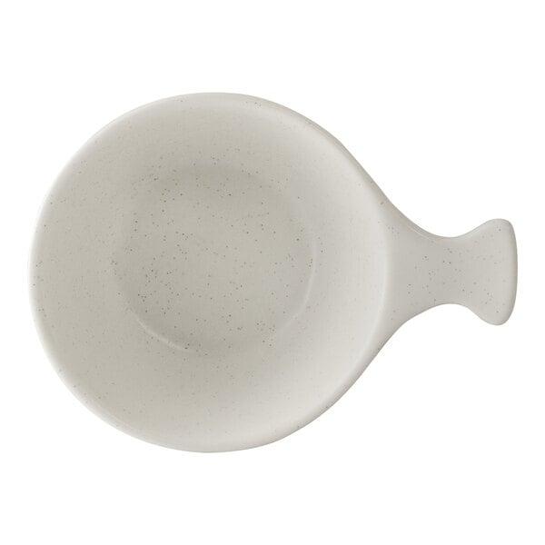 A white porcelain bowl with a handle, shaped like a shell.
