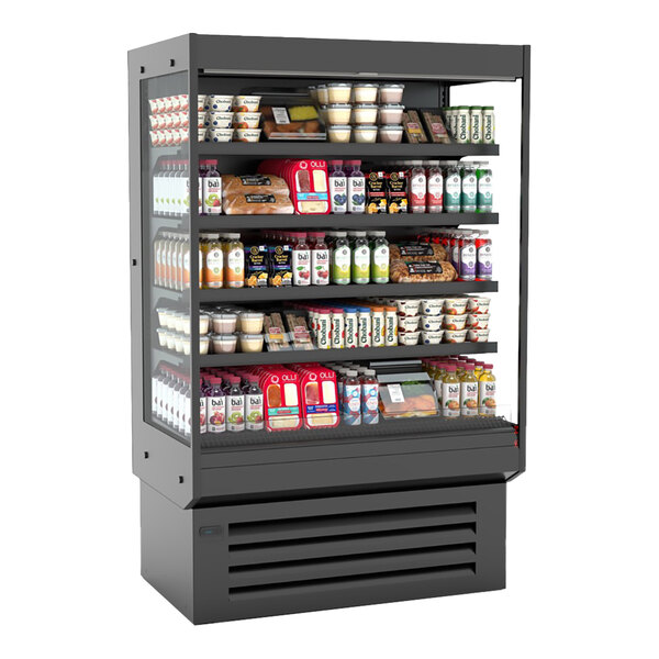 A black vertical open air curtain merchandiser filled with various packaged food and beverage items.