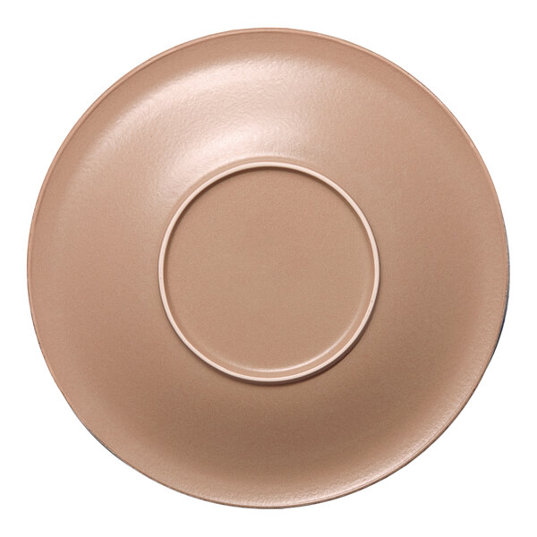 A round, light brown porcelain saucer with a central indentation for holding a cup.