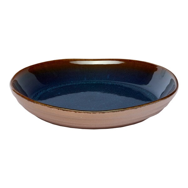 A round blue porcelain coupe bowl with a brown outer edge.