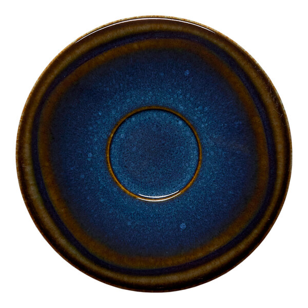 A round blue porcelain coupe saucer with a denim-colored splash design.