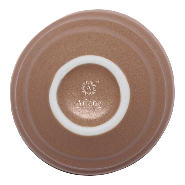 A brown round porcelain ramekin with a white circular base and the brand name 'Ariane' printed on the bottom.