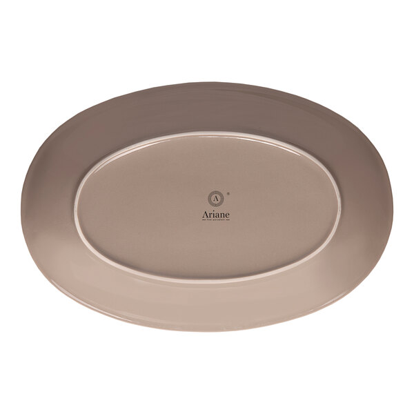 An oval beige porcelain coupe platter with the Ariane logo on the bottom.