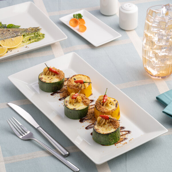 A rectangular ivory porcelain coupe platter displaying assorted stuffed vegetables.