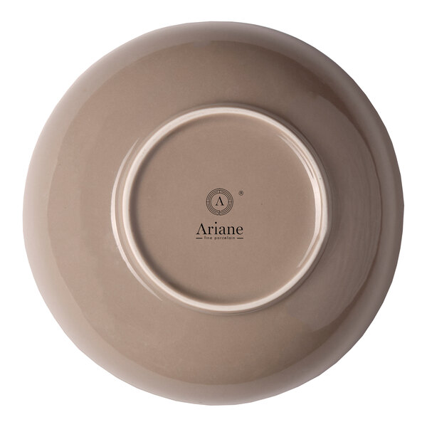 A beige round porcelain coupe bowl shown upside down with the Ariane brand logo on the bottom.