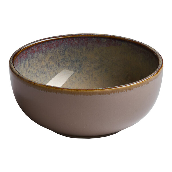 A beige round porcelain coupe bowl with a slightly textured interior.