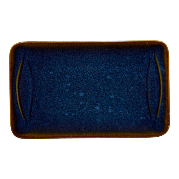 A rectangular blue porcelain platter with a speckled finish and brown edges.