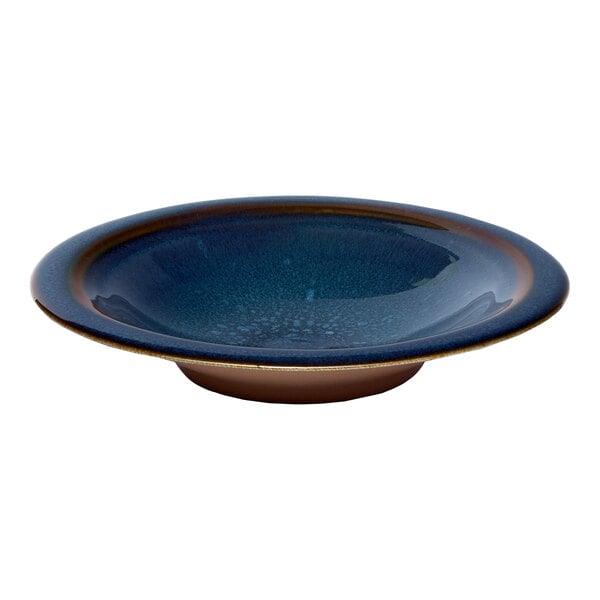 A round blue porcelain coupe deep plate with a denim splash design.