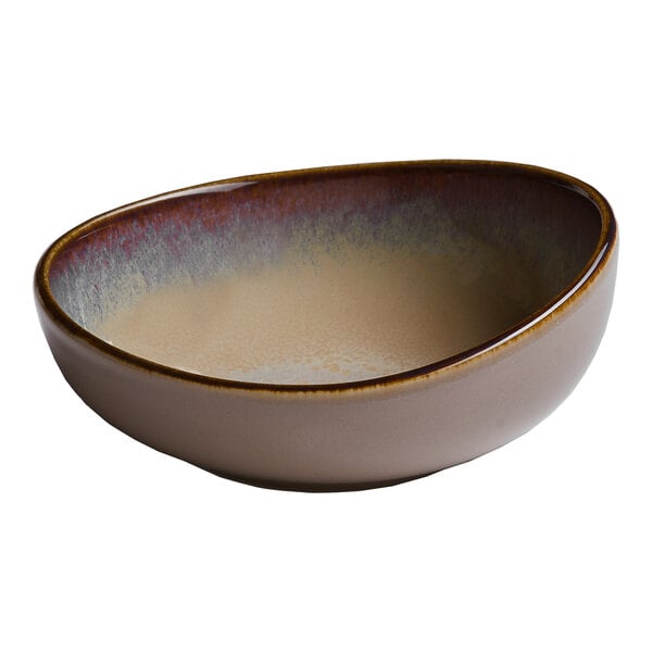 A beige round slanted porcelain coupe bowl with a gradient interior design.