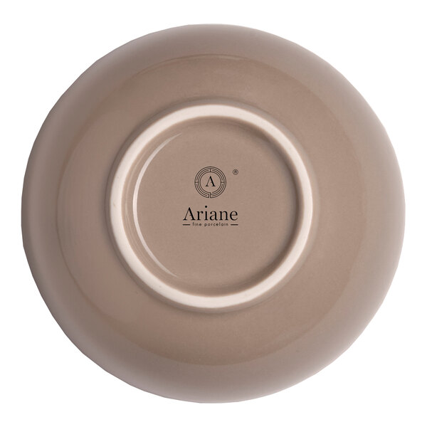 A beige round porcelain coupe bowl shown upside down with the Ariane brand logo on the bottom.